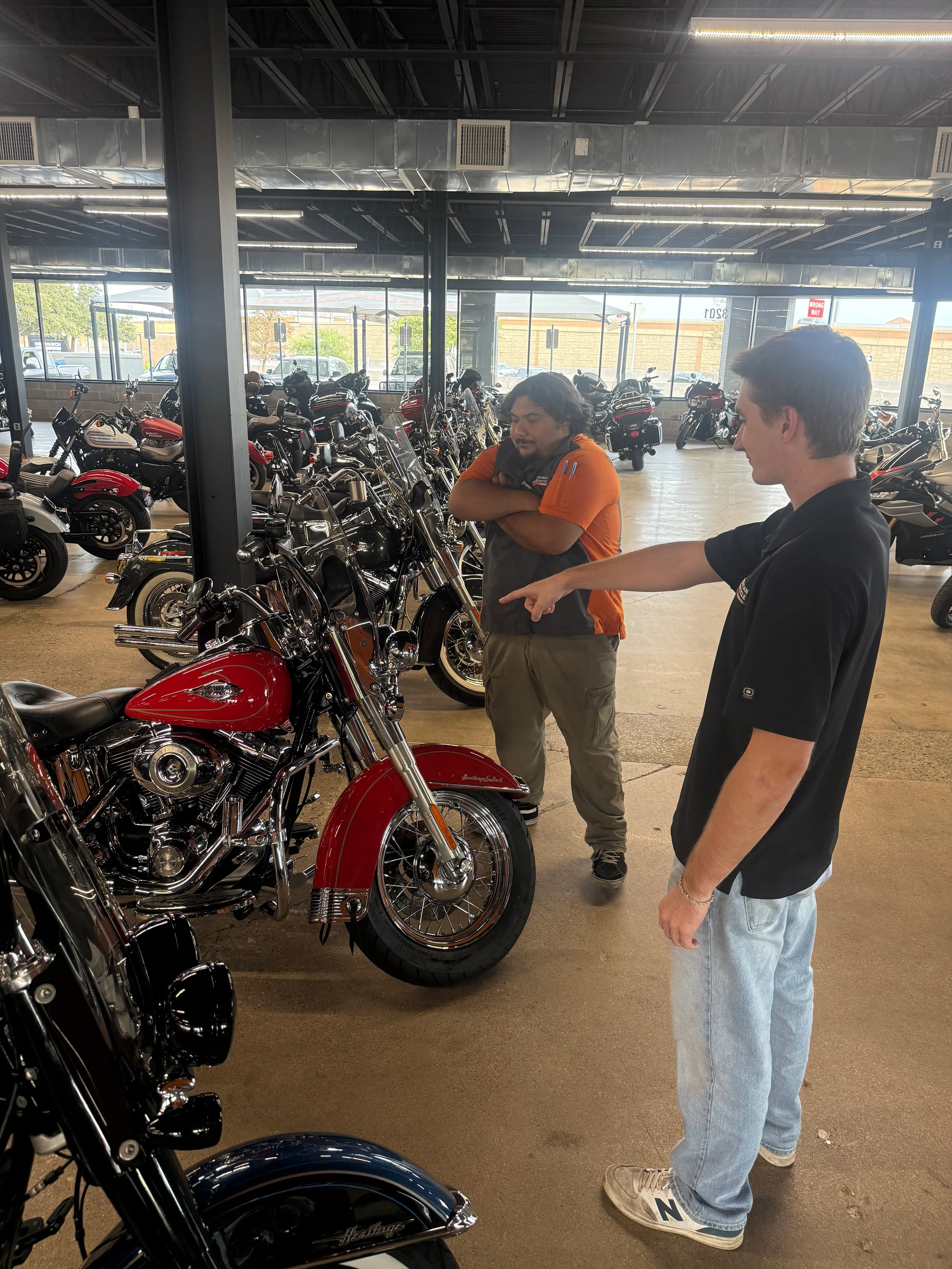 Clean Harleys team helping a shopper compare used Harley-Davidson motorcycles