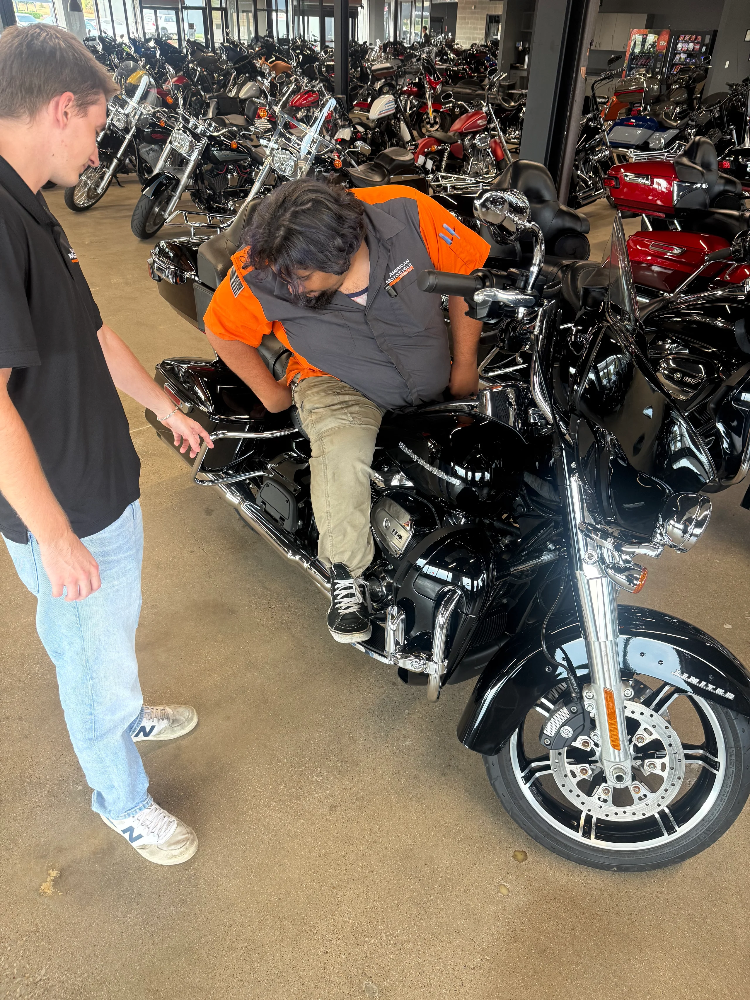 Two riders evaluating a Harley-Davidson touring motorcycle for passenger comfort at Clean Harleys