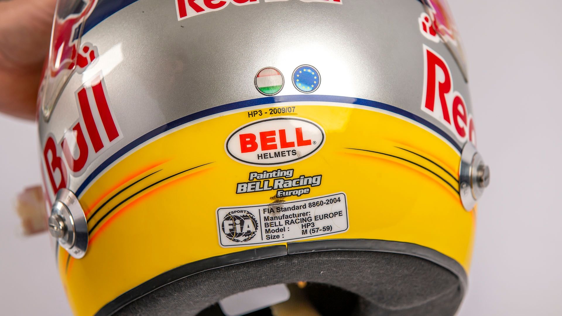 Broad Arrow Auctions | Sébastien Buemi 2009 Signed Original Toro Rosso Helmet with Hungary and European Flags to the Rear