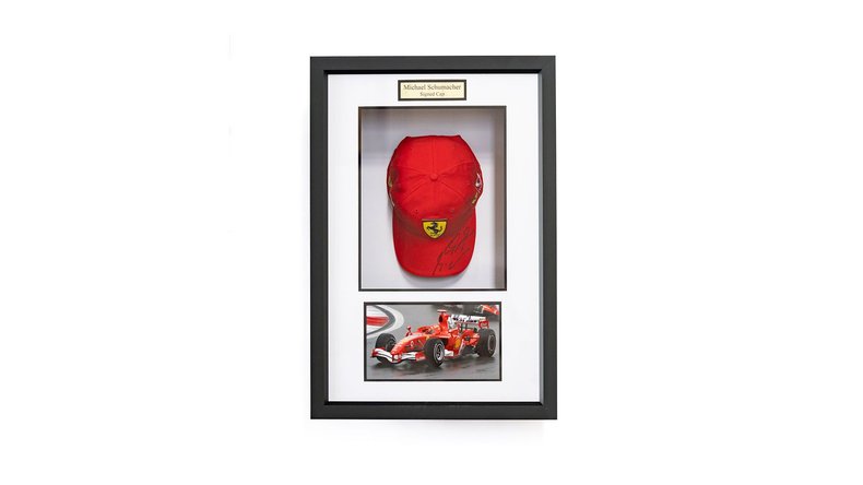 Broad Arrow Auctions | Charity Lot: Michael Schumacher Signed Framed Ferrari Cap