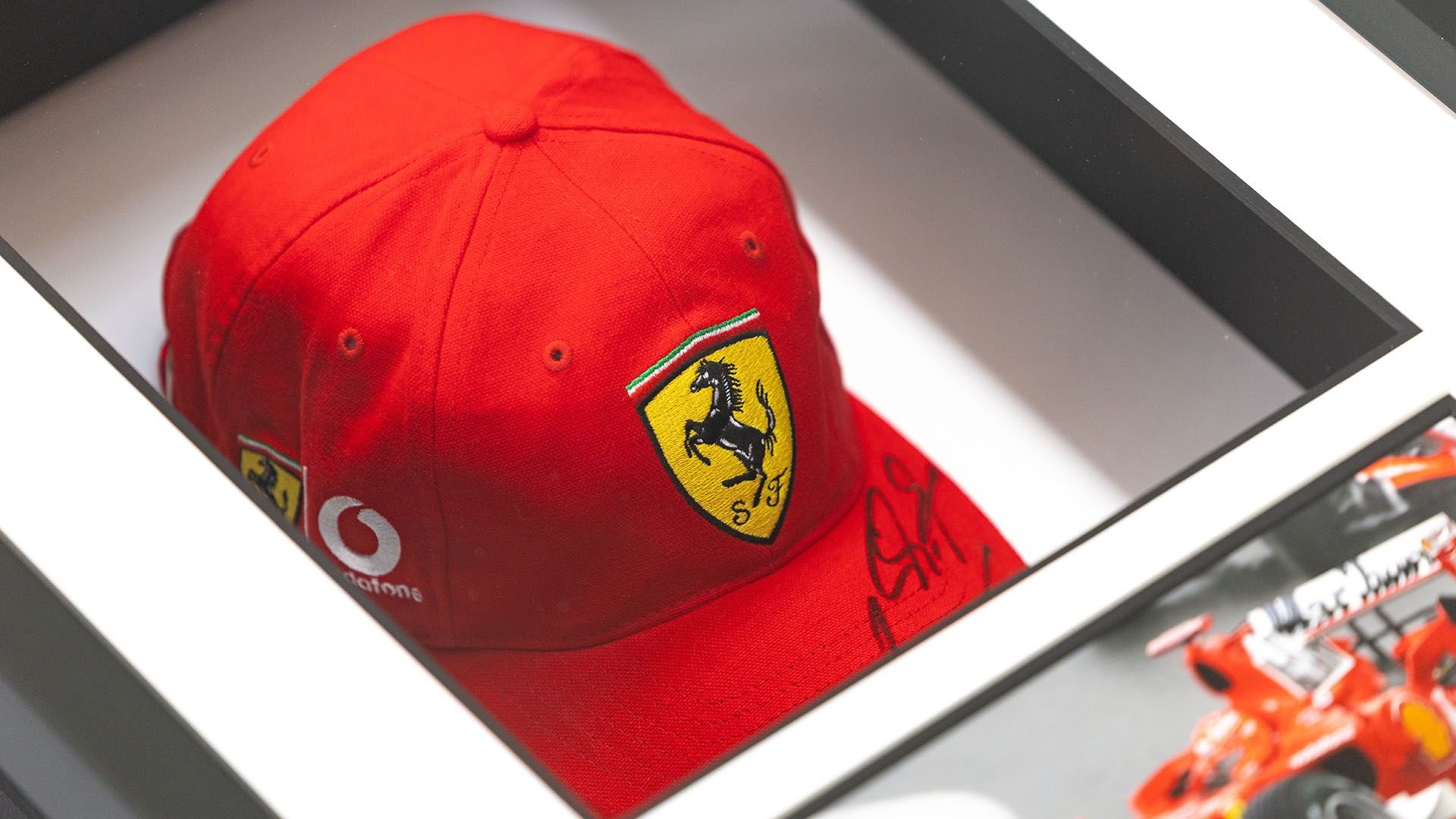 Broad Arrow Auctions | Charity Lot: Michael Schumacher Signed Framed Ferrari Cap