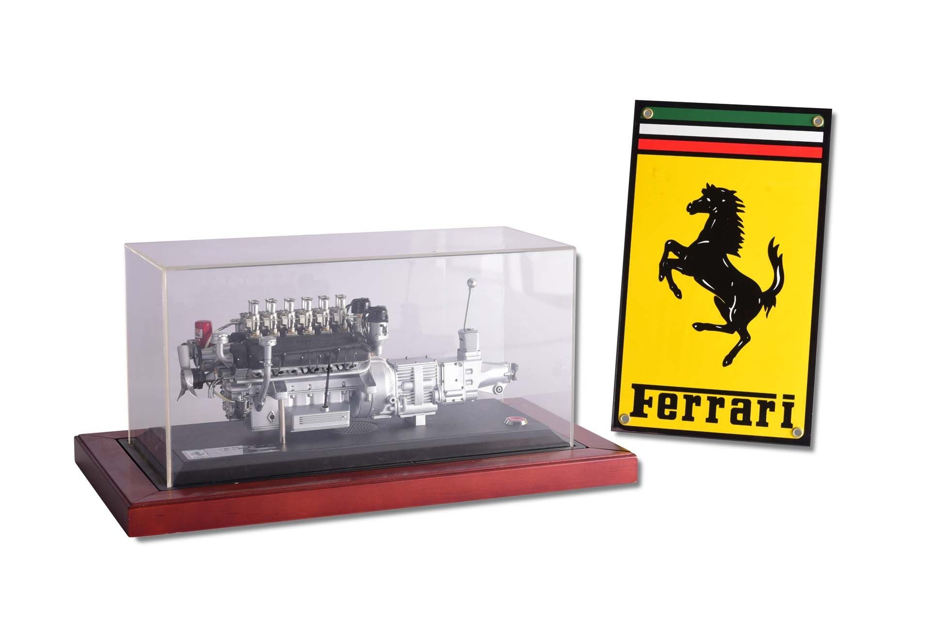 Broad Arrow Auctions | Ferrari Model Engine in Display Case and Small Metal Ferrari Sign