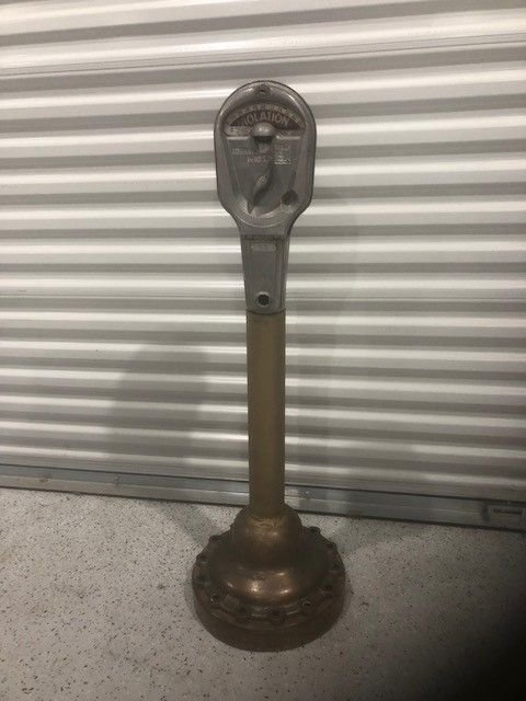 Collectible item antique parking meter on brass like stand